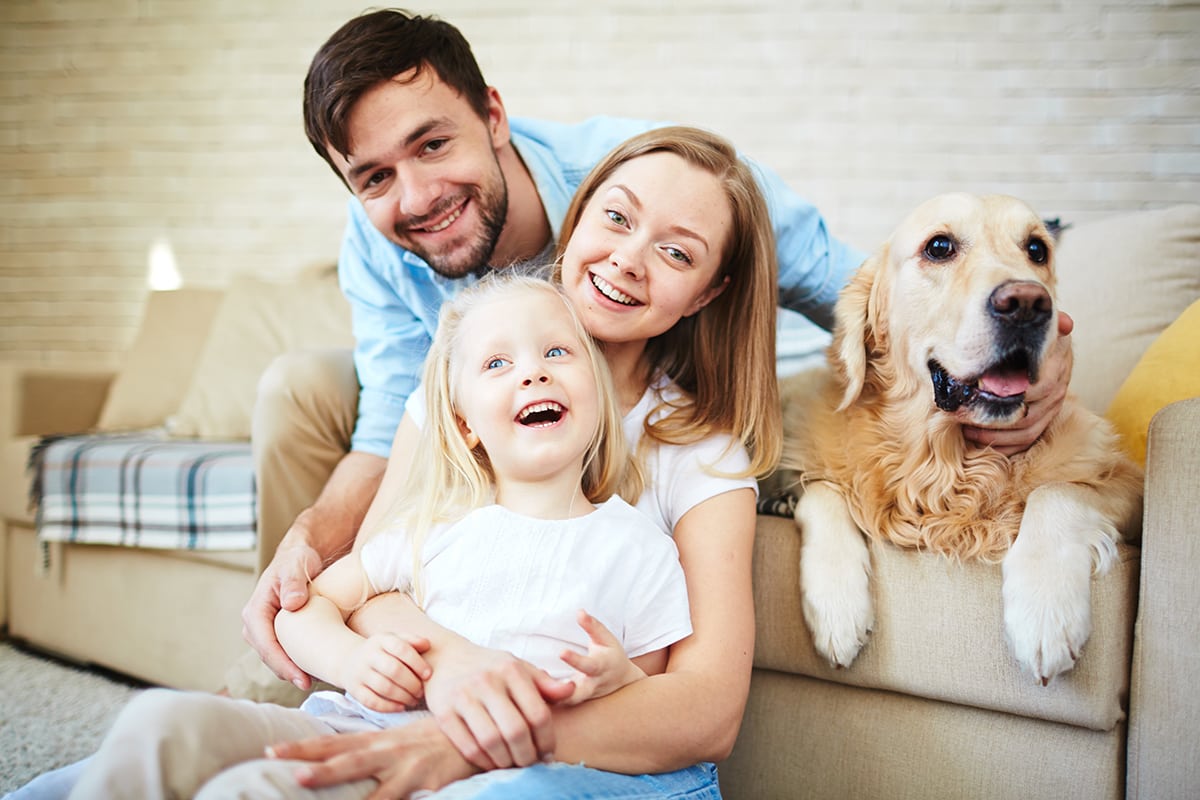Happy Family on Couch with Dog