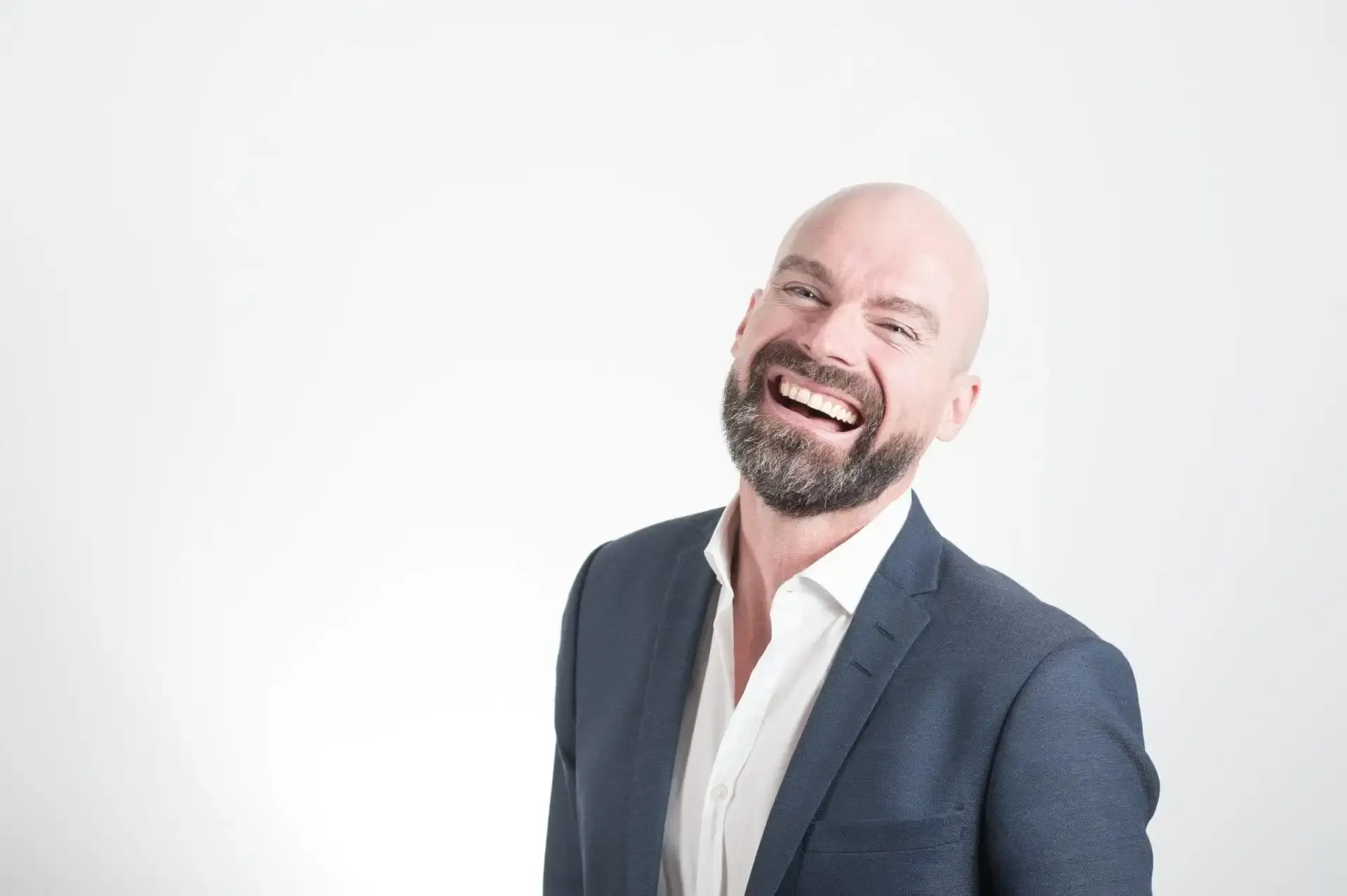 Smiling man in business attire representing successful full mouth restoration results in Albuquerque.